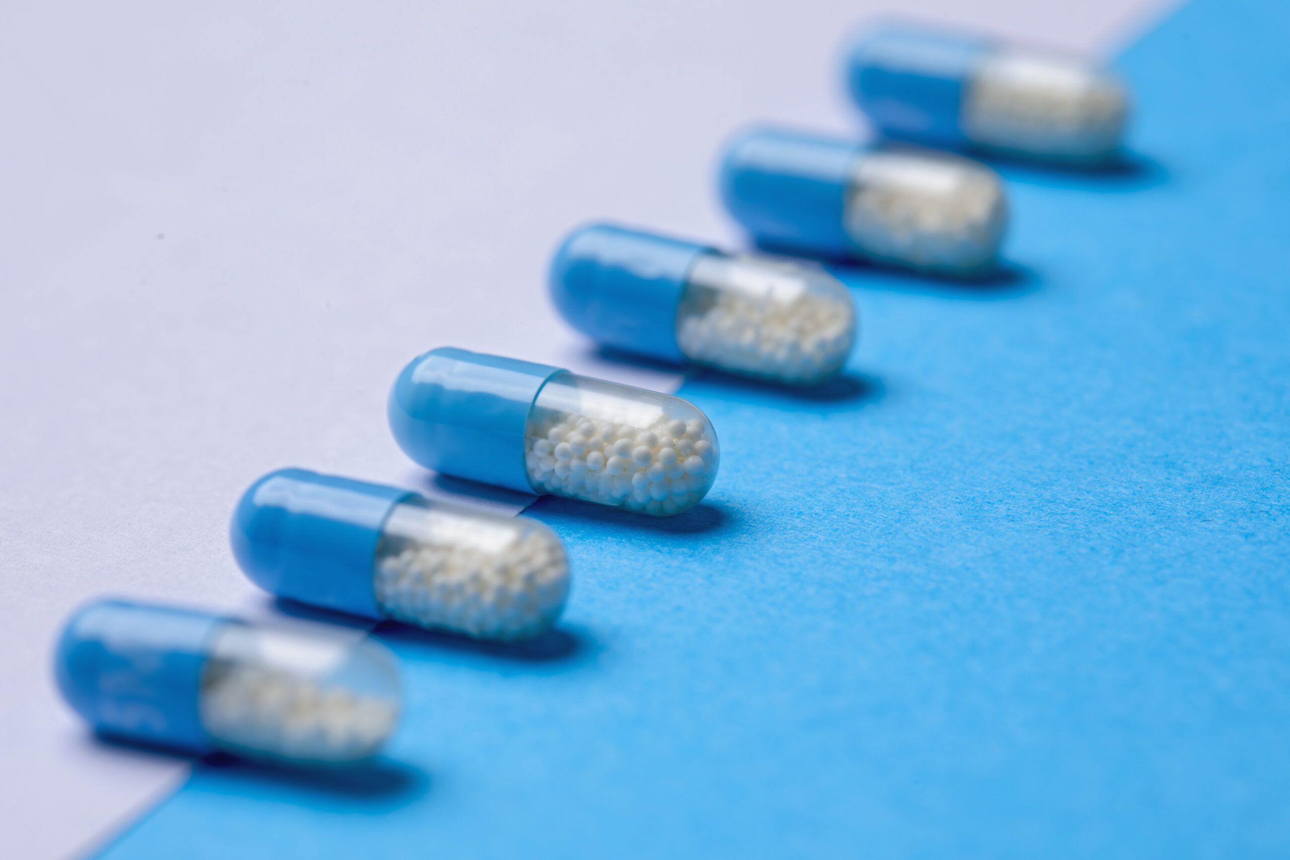 Image of several pill capsules laid out in a line